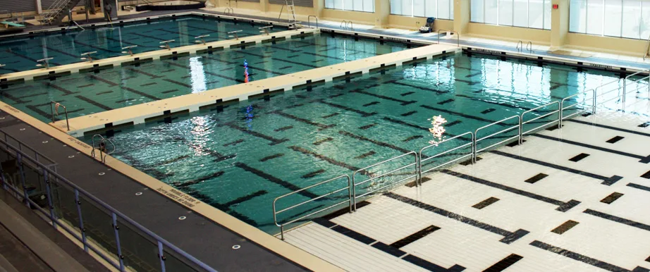 Elevated view of Ithaca College's indoor 50-meter competition pool with a movable bulkhead and lane lines